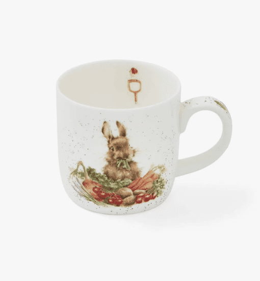 A Wrendale Designs Grow Your Own Rabbit Mug with vegetables on it.
