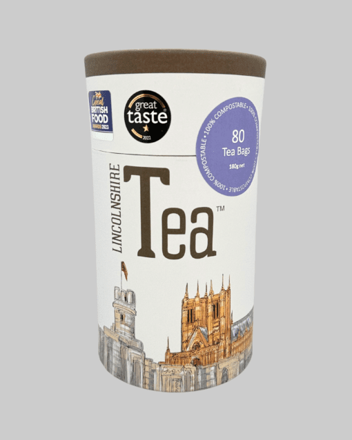 A Lincolnshire Tea Tube 80 Paper Bags with a city in the background.